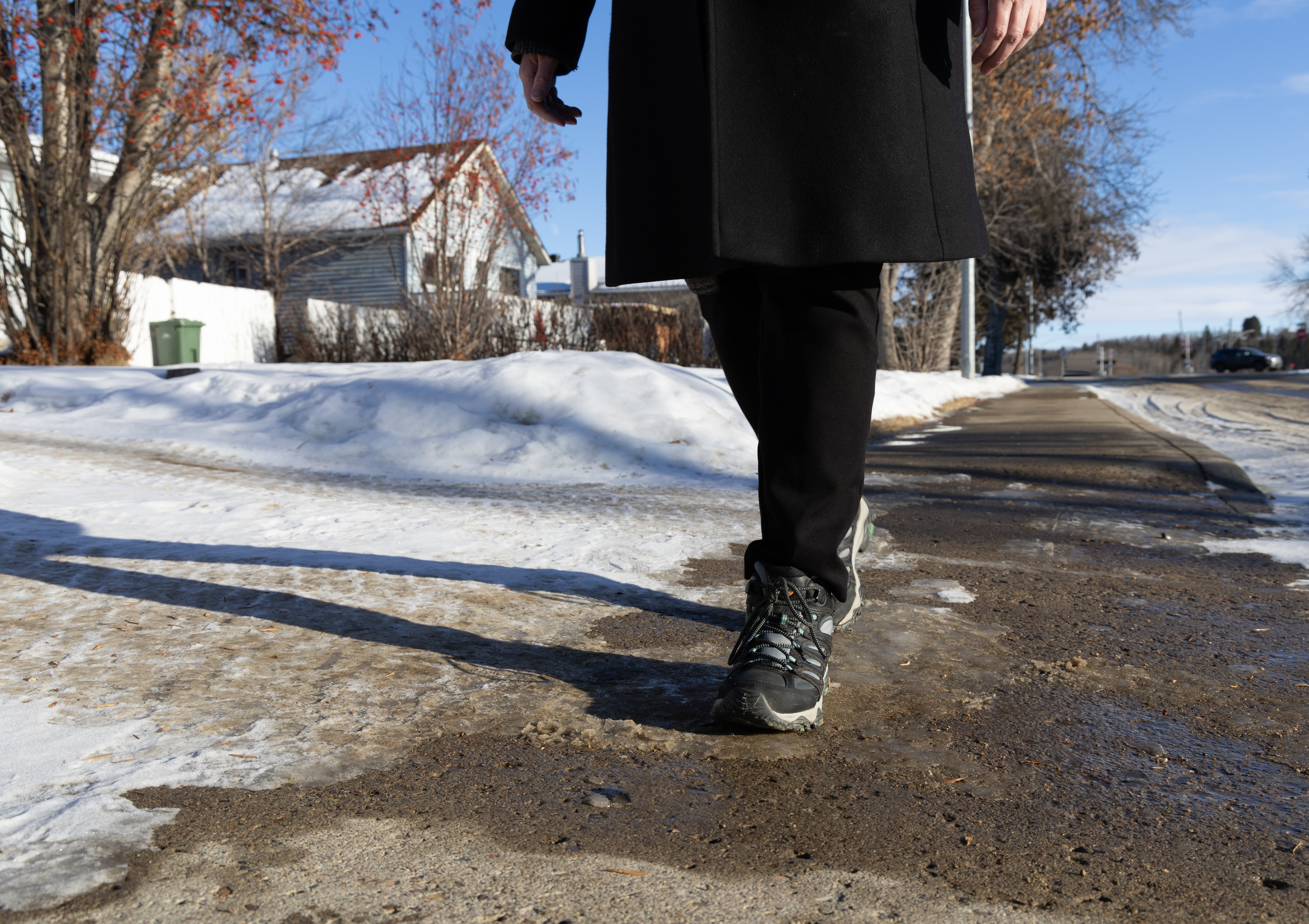 Person walking along a sidewalk