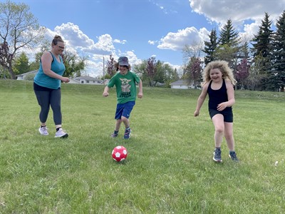Family playing soccer